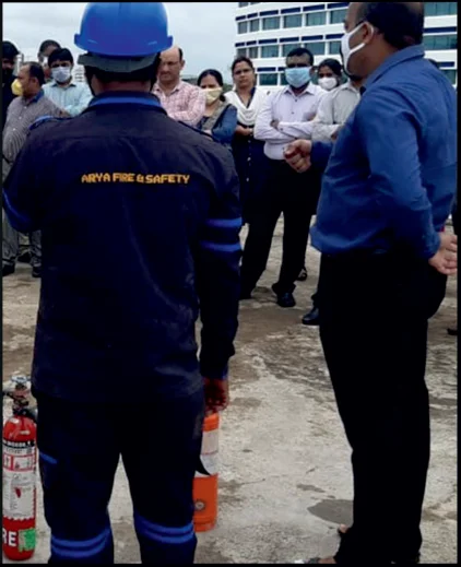Staff of Arya Fire and Safety demonstrating safety measures to take in case of emergency at a company